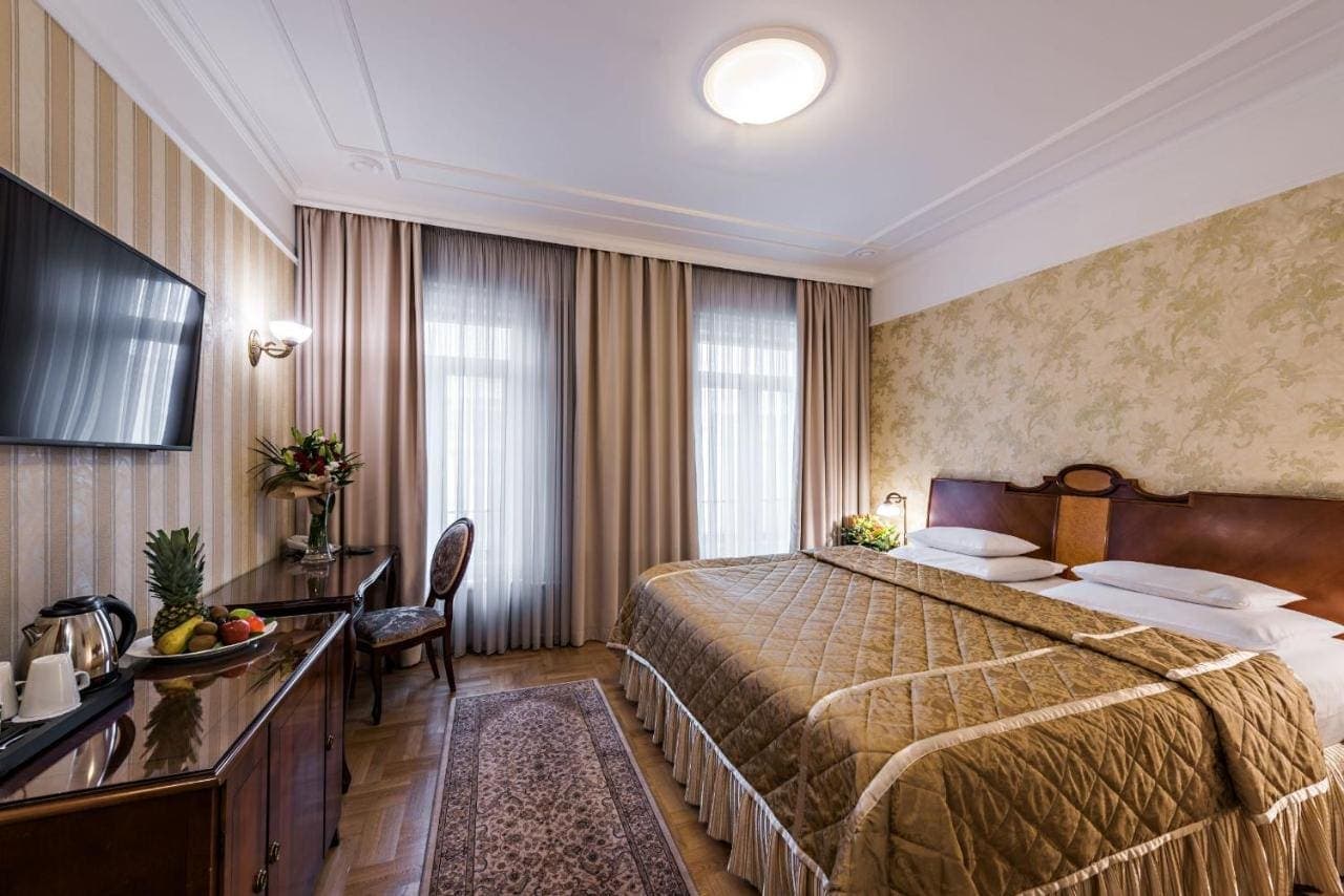 A classic double room with gold drapes