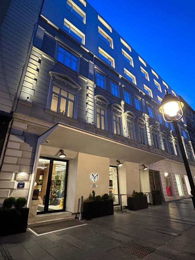 The hotel's lit façade on Čika Ljubina at dusk