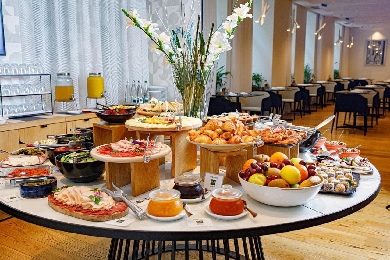 The breakfast buffet with fruit, pastries, and cold cuts