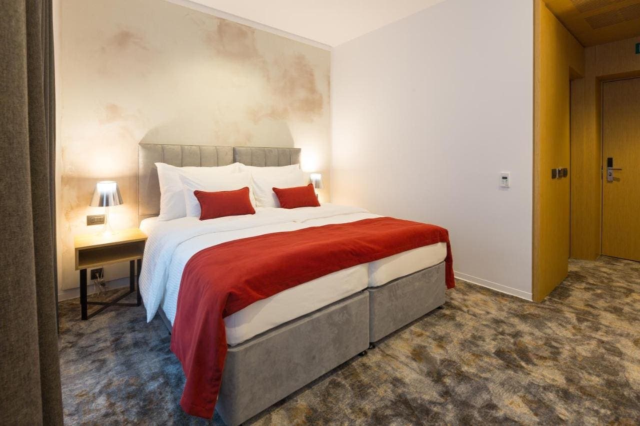 A double room with a red throw