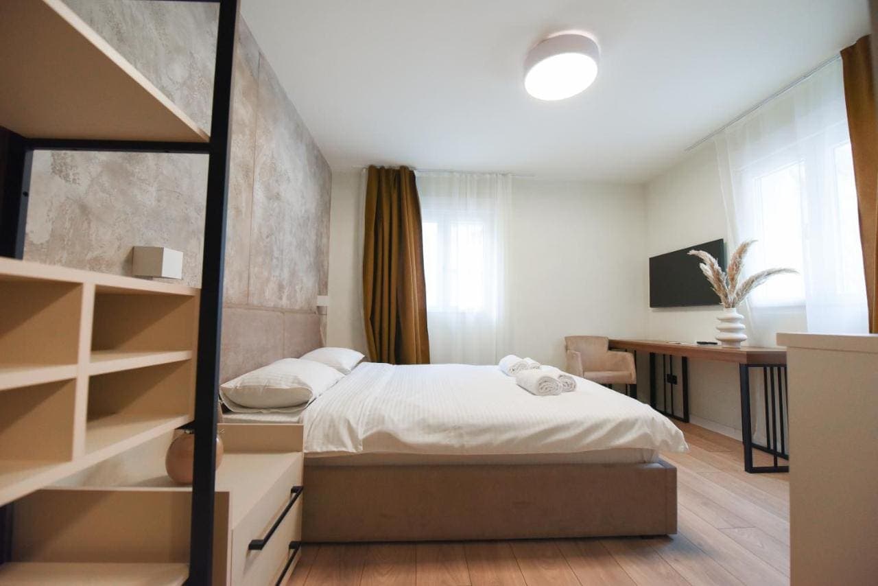 A double room with a desk and open shelving