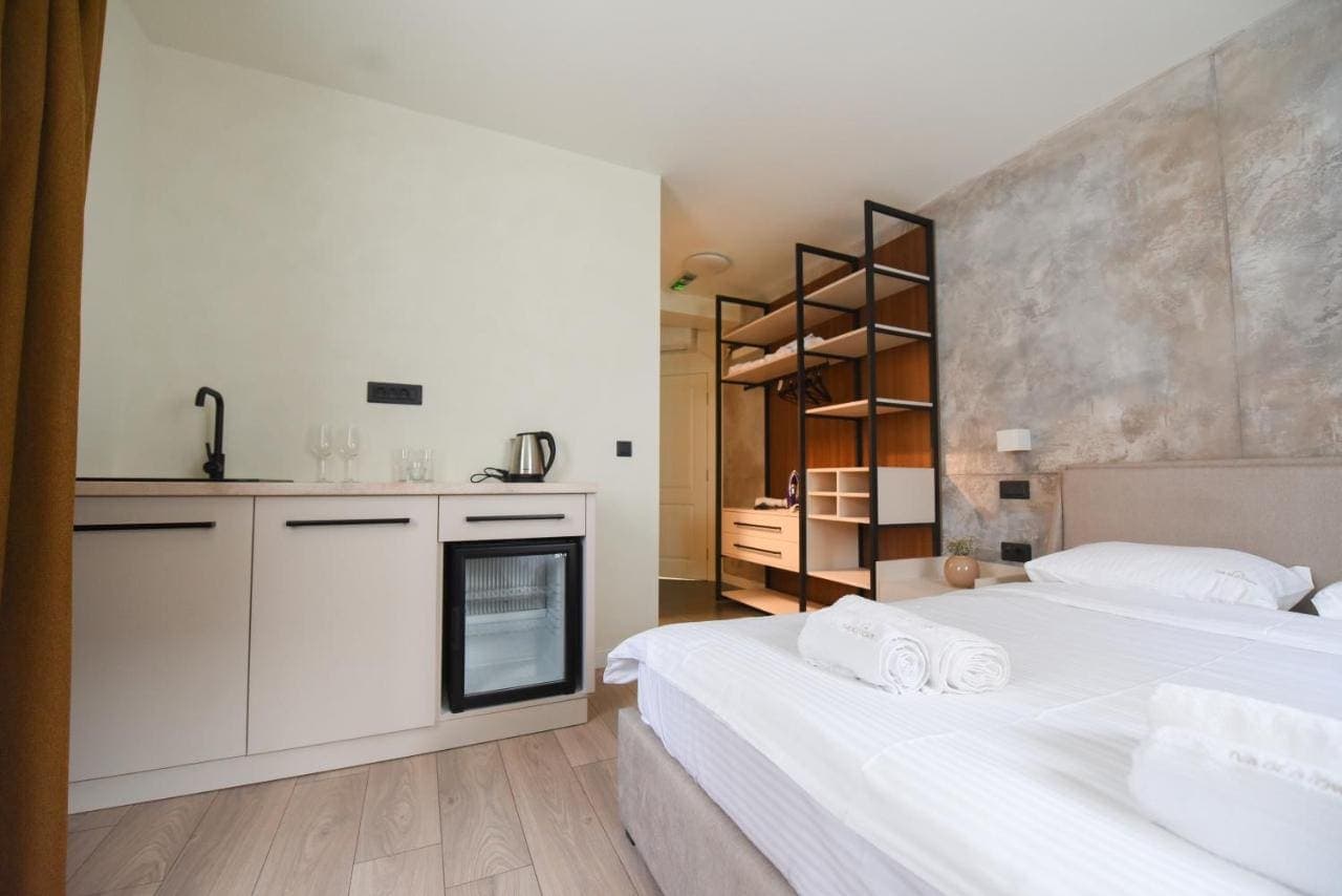 A room with a kitchenette and a large bed