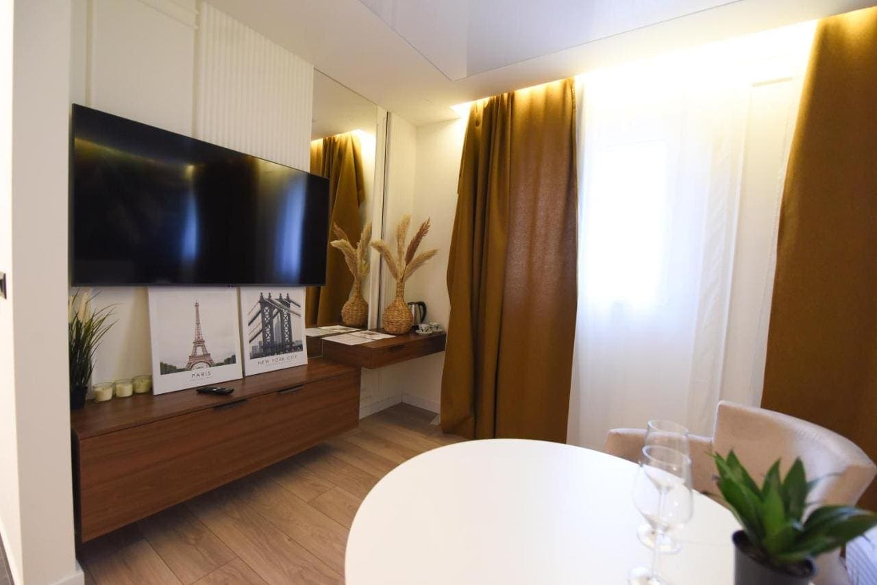 A sitting area with a television and a round table
