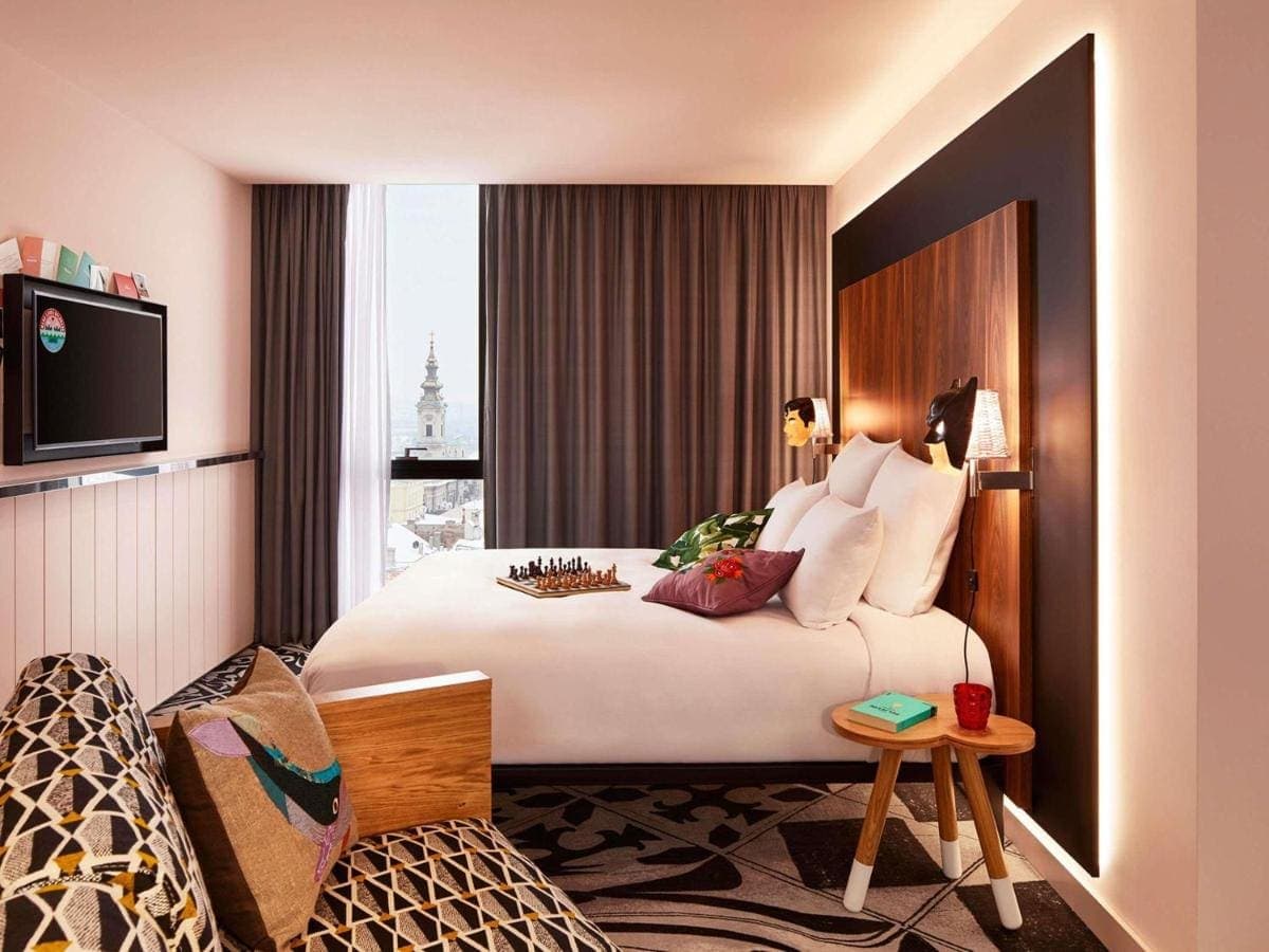 A room with a city view through tall windows