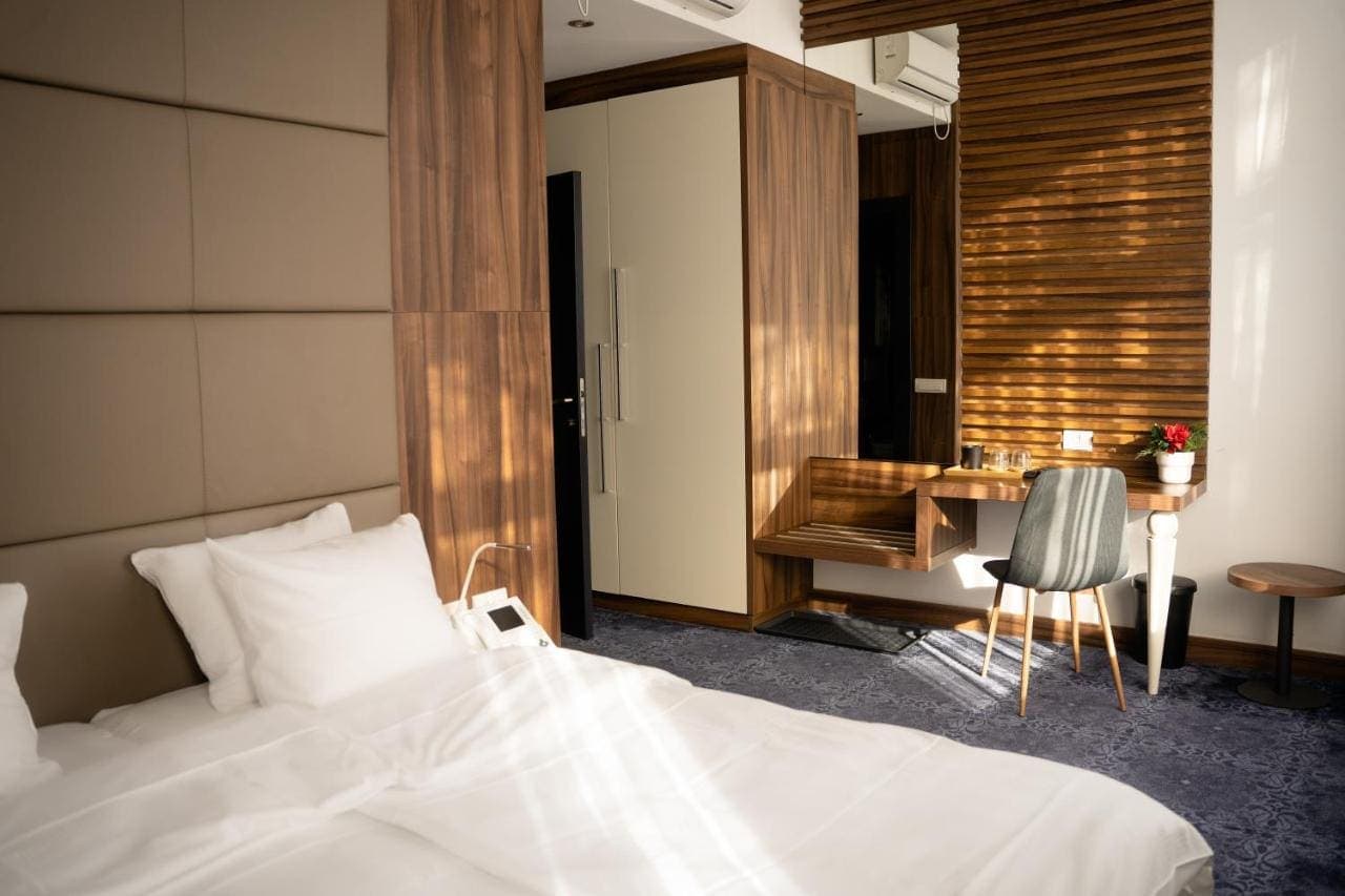 A room with a wood-panelled wall and a desk